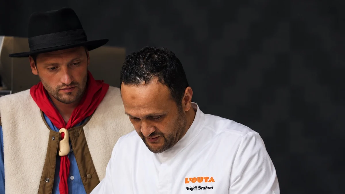 Le chef Wajdi Brahim de L'Outa prépare sa fondue sous le regard d'un berger en gilet de mouton.
